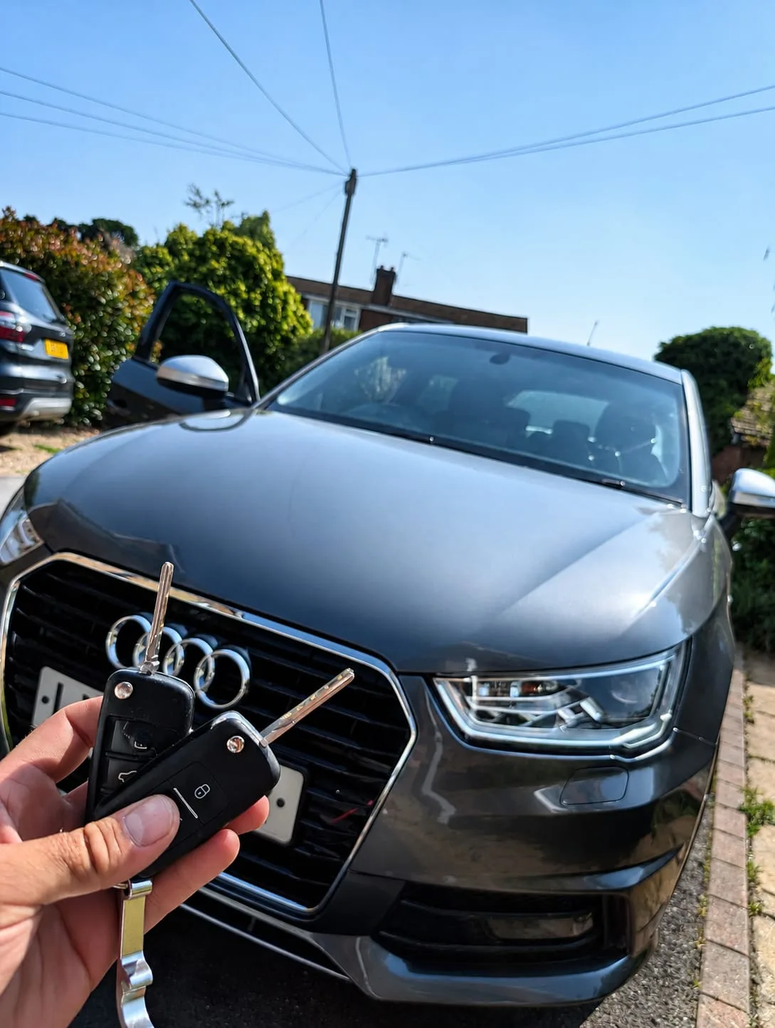 Audi A1 2017 in grey with two new keys held up — West Haddon, Northamptonshire