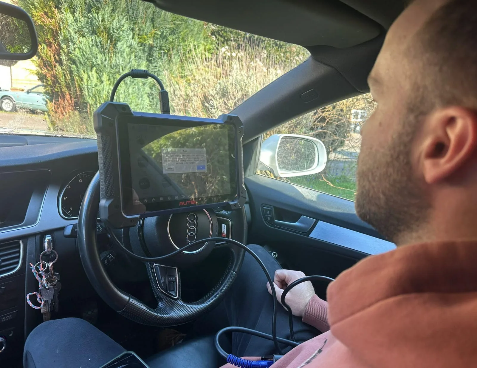Auto locksmith using an Autel diagnostic tablet connected via OBD to an Audi A5 2012 for immobiliser diagnostics in Daventry, Northamptonshire