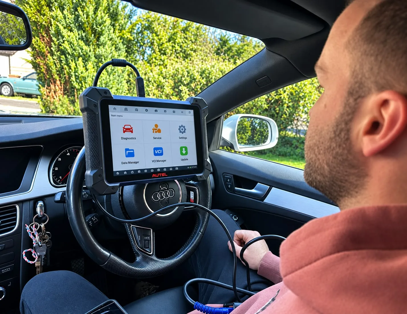 Immobiliser diagnostics in progress inside an Audi — diagnostic tablet connected