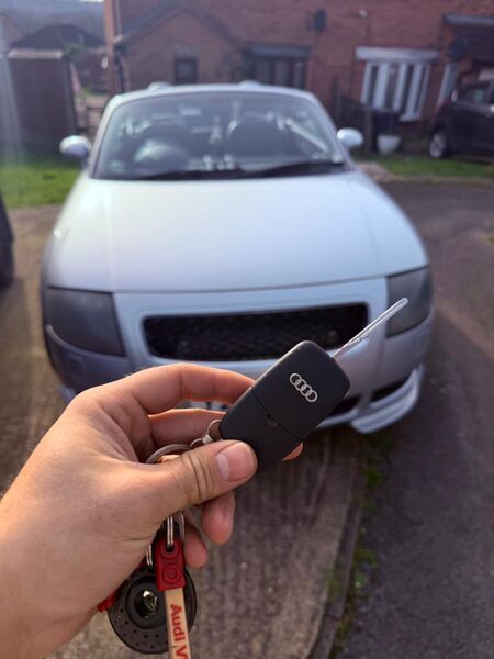 Audi flip key fob replacement with silver Audi in background