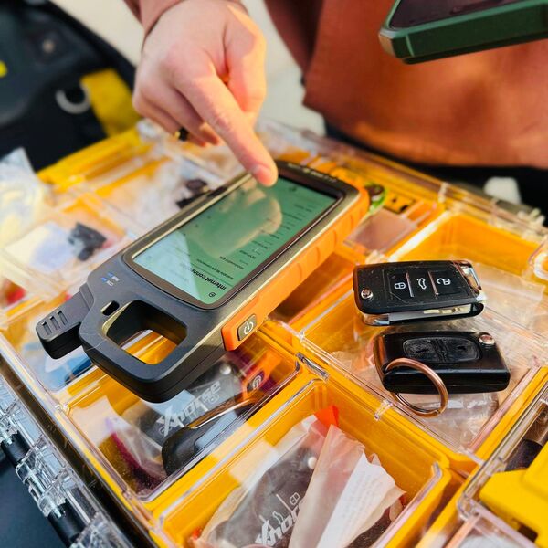 Professional key programming equipment with keys on a DeWalt tray