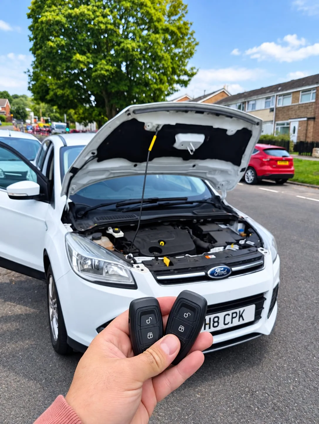 White Ford Kuga 2014 with bonnet open and two new smart keys after all keys lost situation resolved in Daventry