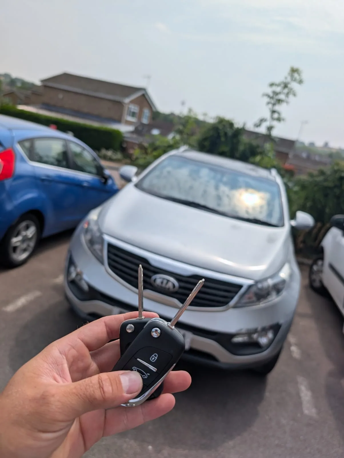 Kia Sportage 2014 in silver with two new flip keys programmed on-site in Daventry, Northamptonshire