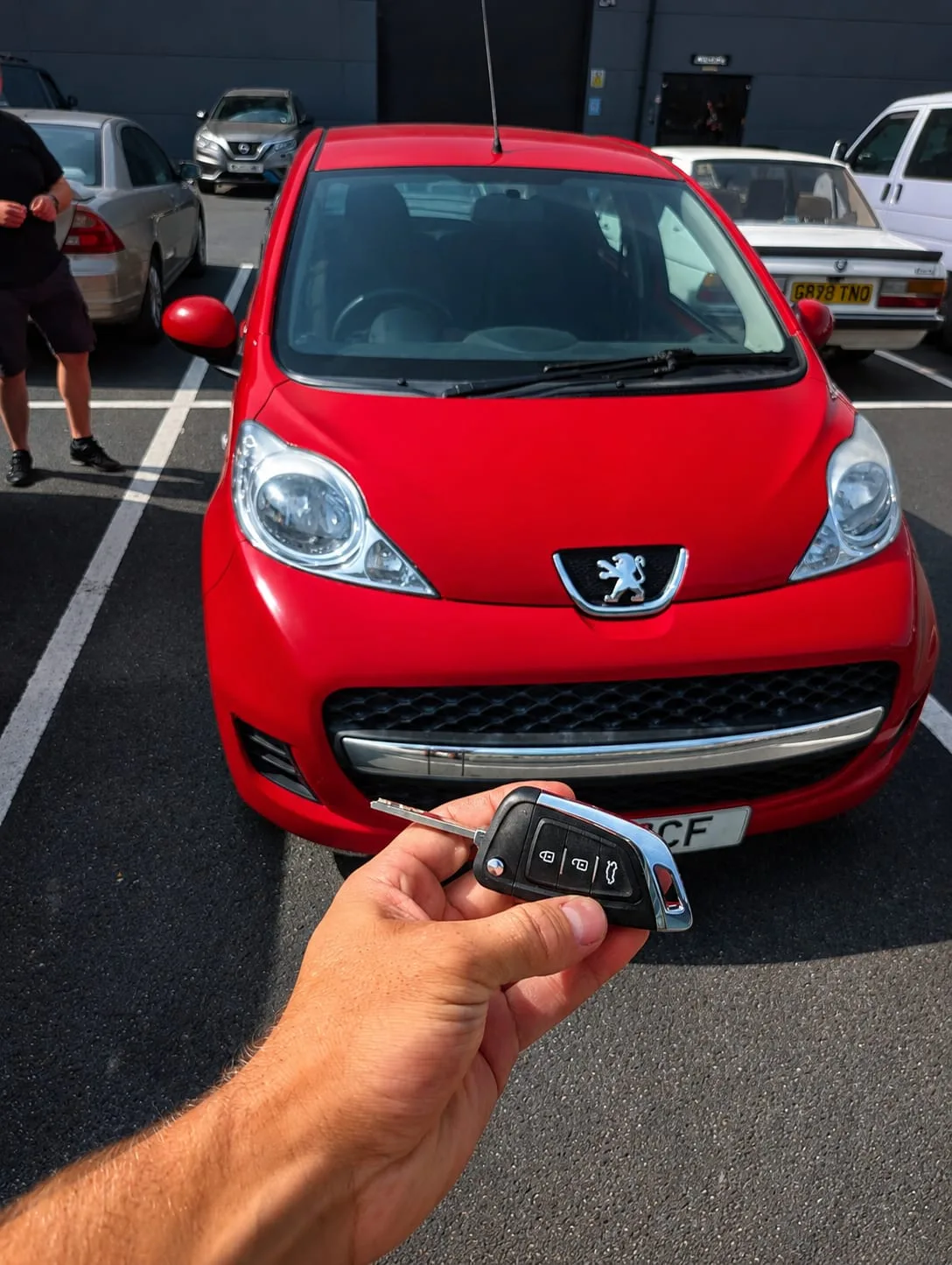 Red Peugeot 107 with new spare key held up in car park — Woodford Halse, Northamptonshire