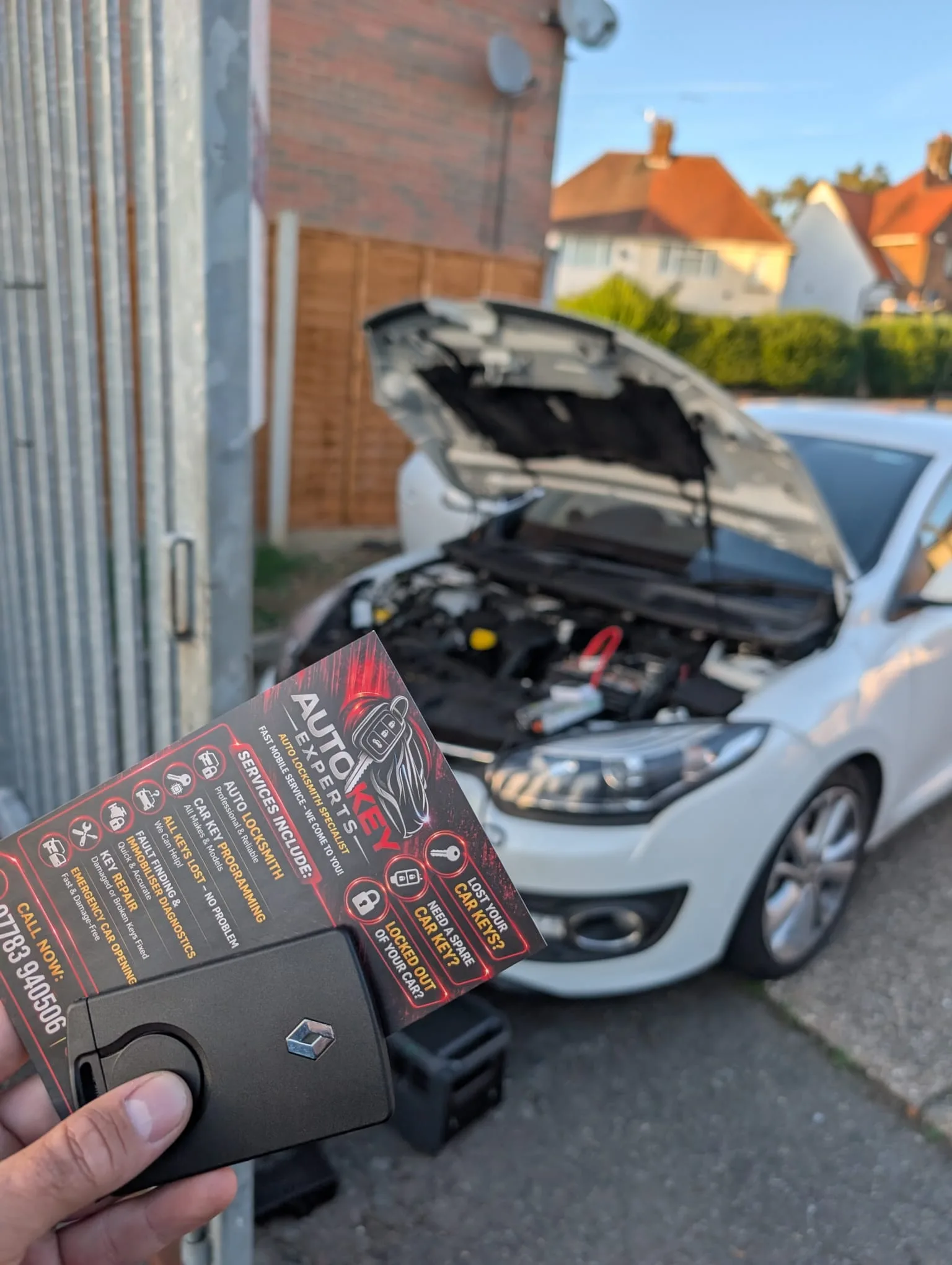 Renault Megane 2014 with bonnet open and new Renault card key programmed on-site in Northampton — all keys lost situation resolved