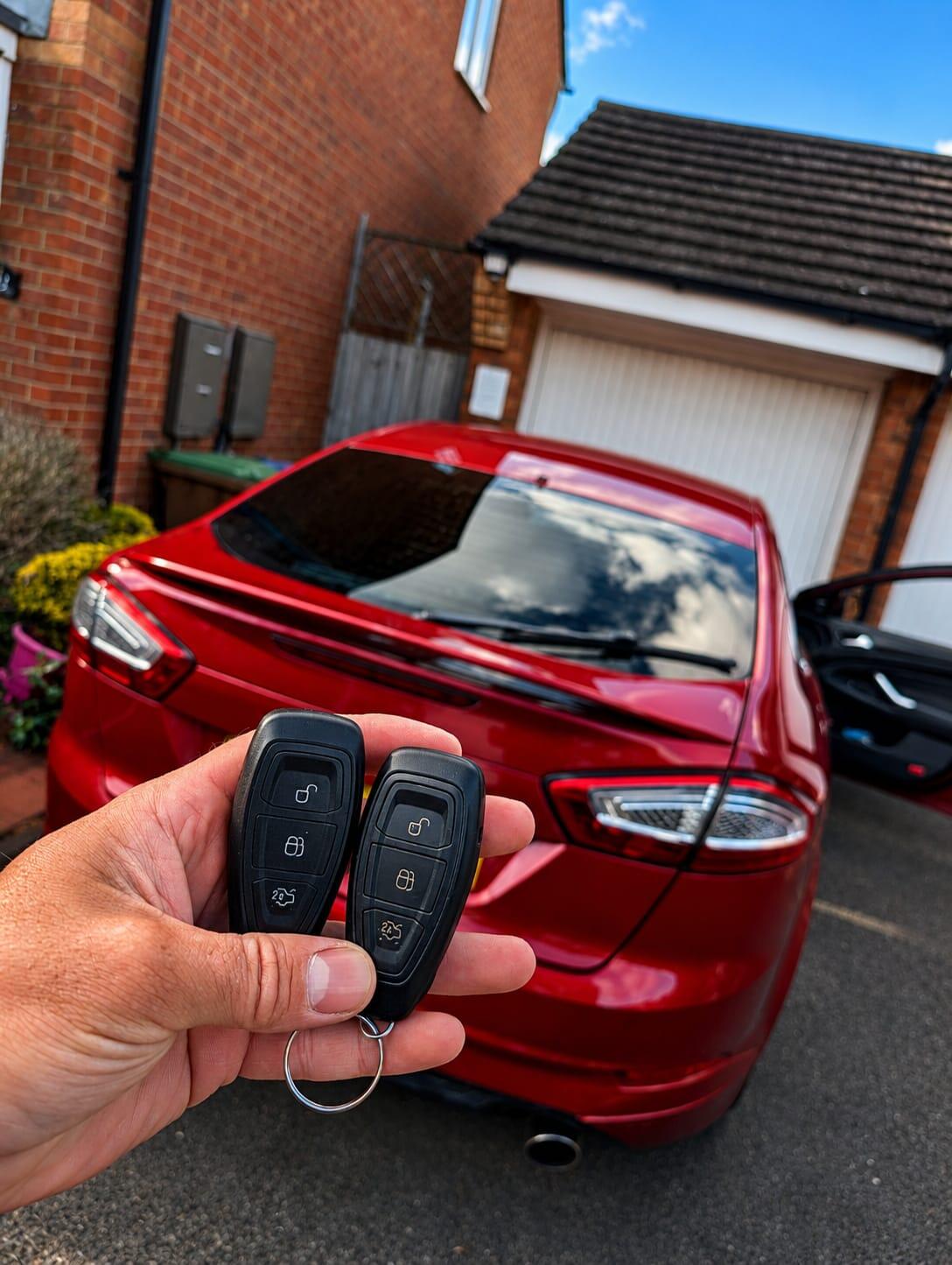 Ford Mondeo - old and new key fobs held up at the job