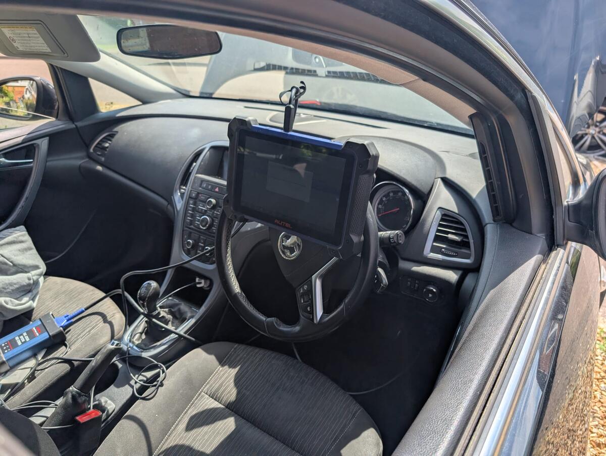 Professional key programmer working on vehicle